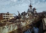 German cruiser Admiral Hipper in dry dock at Kiel, Germany after being captured by the Allies, 19 May 1945. Note German attempts at camouflage and damage from Allied bombing.