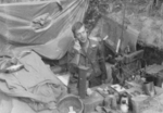 Sergeant Chestnut of US 5332nd Brigade (Provisional) using a field telephone, Burma, 1945