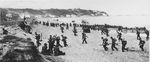 United States Army troops landing near Algiers, Algeria, 8 Nov 1942. Note the large American flag they carried in the hopes French troops would not fire on it.