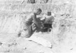 Member of US 5332nd Brigade (Provisional) tending to a rum baker, Burma, 1945