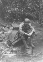 Colonel James Donovan of US 5332nd Brigade (Provisional) resting at a stream in Burma, 1945