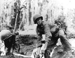 United States Marine preparing to throw a Mark II “pineapple” grenade on Guadalcanal, Solomon Islands, 1942. Note Browning Automatic Rifle at left.