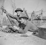 2-inch mortar team of 2nd London Irish Rifles firing mortar rounds at German positions on Senio River, Italy, 22 Mar 1945