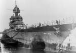 Battleship USS Maryland entering Drydock No. 2 at Pearl Harbor, Hawaii 11 Jul 1944 for repairs to her bow caused by an aerial torpedo that struck the ship while at anchor in Saipan Harbor, Mariana Islands 22 Jun 1944.