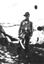 Bob Compton of US 5332nd Brigade (Provisional) cleaning his Thompson submachine gun, Camp Landis, Kachin, northern Burma, Dec 1944