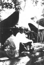 John Blackburn giving Bill Hale a haircut, Camp Landis, Kachin, northern Burma, Dec 1944; they were both of US 5332nd Brigade (Provisional)