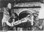 Dachau survivor demonstrating the operation of the camp crematorium, May-Jun 1945