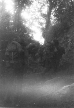 James W. Gustin, Jr. and other men of US 5332nd Brigade (Provisional) and US 124th Cavalry Regiment on a trail, northern Burma, early Jan 1945