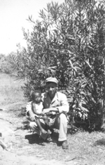 Sam Pierson of the US Army Medical Detachment 1340 with civilian child, Fiji, 1942-1944