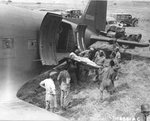 British and American servicemen loading wounded soldiers onto a C-47 Skytrain transport at Agrigento, Sicily for transportation to hospitals in Africa, 25 Jul 1943. Note litter Jeep and WC54 ambulances.