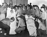 Capt Dixie Kiefer (left) and executive officer Cdr Willian Burch, both badly injured in an air attack four days earlier, being prepared for transfer from Ticonderoga to the hospital ship Samaritan at Ulithi, 25 Jan 1945