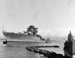 Battleship USS West Virginia leaving Drydock #1, Pearl Harbor, Hawaii, 9 Sep 1942 following preliminary repairs of damage sustained in the Japanese attack. Note the mast and portions of the upper hull have been removed.