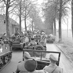 During their tour of the assault on the Rhine, British Prime Minister Winston Churchill and Field Marshal Bernard Montgomery stopped their Jeeps to allow troops to pass in troop carriers, 26 Mar 1945.