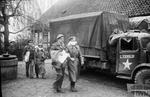 British officers leading two blindfolded German officers through the British lines at Winsen, Germany for a truce negotiation in connection with the typhus-infected camp at Bergen-Belsen, Apr 1945.