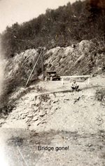 US Army serviceman at the remnants of a bridge, France, May 1945