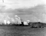 As seen from battleship USS Texas, Fletcher-class destroyer USS Twiggs engaging in a pre-invasion bombardment of Iwo Jima’s landing beach White 2 in support of underwater demolition team operations, about 1600 hours on 17 Feb 1945.