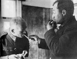 Soviet Major General Vladimir V. Kirpitsnikov, in captivity, lighting a cigarette for Finnish Lieutenant General Lennart Oesch, Russia, Sep 1941