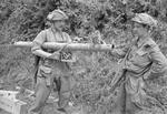 Sergeant F. J. Petrie and sapper L. Roberts examining a captured German Panzerschreck weapon, south of Caumont, France, 31 Jul 1944