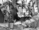 United States Navy Photographers Mate Don Garber of the Air Center Photo Lab at Espiritu Santo, New Hebrides holding a fruit bat, common on the island, circa 1944.