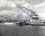 USS Current alongside Pearl Harbor Salvage Dock as Floating Crane YD-121 lifts a Japanese Type A Kō-hyōteki-class midget submarine used in the Pearl Harbor Attack salvaged from Oahu’s Keehi Lagoon, 14 Jul 1960.