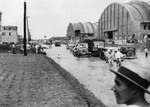 Hangars 3 and 2 under construction at Borinquen Field, Puerto Rico, 1941. Note the flooded roadway and crops planted alongside the road.