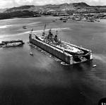 USS Wisconsin in floating drydock ABSD-1 in Apra Harbor, Guam, 5 Apr 1952. Note Oregon, the ex-battleship converted to ammunition barge, in the distance off Wisconsin’s bow.