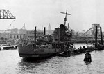 Destroyer USS Shaw with her bow blown off and settled in the sunken floating drydock YFD-2 in Pearl Harbor, Hawaii, mid-Dec 1941. Photo 2 of 2.