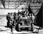 American and Soviet servicemen crowd around a Jeep at Poltava air base, Ukraine during Operation Frantic, 21 Jun 1944.