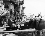 Busy flight deck of the USS Saratoga, 5 Nov 1943. In the foreground is an SBD Dauntless while F6F-3 Hellcats land astern after a strike against Rabaul in support of Bougainville operations.