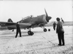 WAAF flight mechanics pulling chocks away from a Miles Martinet TT Mark I target tug of No. 289 Squadron RAF at RAF Turnhouse, Edinburgh, Scotland, United Kingdom, 1943-1945