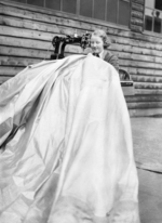 WAAF member machine stitching a patch onto a kite balloon at an RAF station in the United Kingdom, May 1940