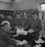 Leading Aircraftwoman Vera Blackbee collecting her pay, WAAF Demobilisation Centre, RAF Wythall, Worcestershire, England, United Kingdom, 1945