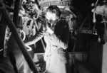 WAAF signals officer testing the intercom system in an Avro Lancaster aircraft at a Bomber Command station, United Kingdom, 1942-1945