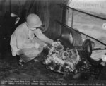 Broken pieces of the engine from a Mitsubishi A6M Zero fighter aircraft that crashed through the flight deck of escort carrier USS Suwannee during the Battle off Samar, 25 Oct 1944.