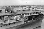 USS Ranger at Montevideo, Uruguay with Vought O3U-3 Corsairs on deck, 24 Sep 1934. British heavy cruiser HMS Exeter in the background.