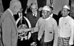 Burmese Prime Minister U Nu presenting a USD $5,000 check to US President Dwight Eisenhower for the families of Americans who fell in Burma during WW2, White House, Washington DC, United States, 3 Jul 1955; John Foster Dulles and U Thant in background