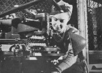 Female worker operating an engraving machine for a Sten part, Small Arms Ltd. plant, Mississauga, Ontario, Canada, May 1941