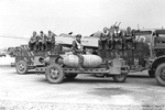 Lt Stanley Stedt, a bombardier with the 306th Bomb Group, sitting astride a 4,000-pound bomb while fellow airmen sit atop cases of .50-caliber ammunition, RAF Thurleigh, Bedfordshire, England, Jul 1943.