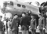 King George VI of the United Kingdom, shadowed by his daughter, Princess Elizabeth, speaks with Colonel George Robinson, commanding officer of the 306th Bomb Group, RAF Thurleigh, Bedfordshire, England, 6 Jul 1944.