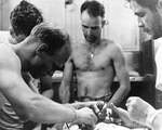 Emergency surgery being performed in the wardroom of the Gato-class submarine USS Silversides while at sea, 22 Dec 1942. The procedure was performed not by a surgeon but by Pharmacists Mate 1c Thomas Moore.