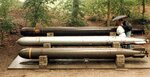 A display of three World War II torpedoes from three nations. Top, a British Mark IX; middle, a German G7e(TIII); and bottom, a US Mark XVIII.