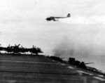 A burning Yokosuka P1Y Ginga ‘Frances’ aircraft crossing astern of escort carrier USS Ommaney Bay in the Sulu Sea, Philippines, 15 Dec 1944. Moments later, the airplane crashed into the sea.