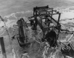 Wrecked Mikazuki being inspected by USMC personnel, off Cape Gloucester, New Britain, 8 Feb 1944; note depth charge mortar and rack