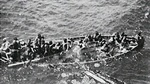 Life boat from SS Tilawa in process of sinking due to overloading as seen from cruiser HMS Birmingham, 25 Nov 1942.