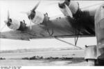 German servicemen resting in the shadow of a Me 323 Gigant aircraft