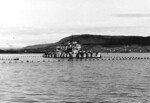 German anti-aircraft ship Nymphe in camouflage and surrounded by torpedo nets, Norway, 1940