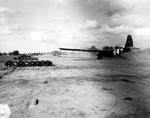 CG-4A glider making a training landing at Beuzeville Airfield, Sainte-Mère-Église, France, Jun 1944; note invasion stripes.