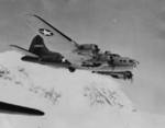 B-17 Flying Fortress bomber in flight over Mount Rainier, Washington, United States, 28 Jul 1943; note the special external hardpoints modification