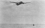 G4M1 bomber of Japanese Navy 4th Air Group commander Lieutenant Masayoshi Nakagawa, moments before crashing into sea during attack on USS Lexington off Bougainville, Solomon Islands, 20 Feb 1942. Photo 1 of 2