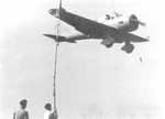 Ki-36 aircraft in flight over an airfield, circa 1940s